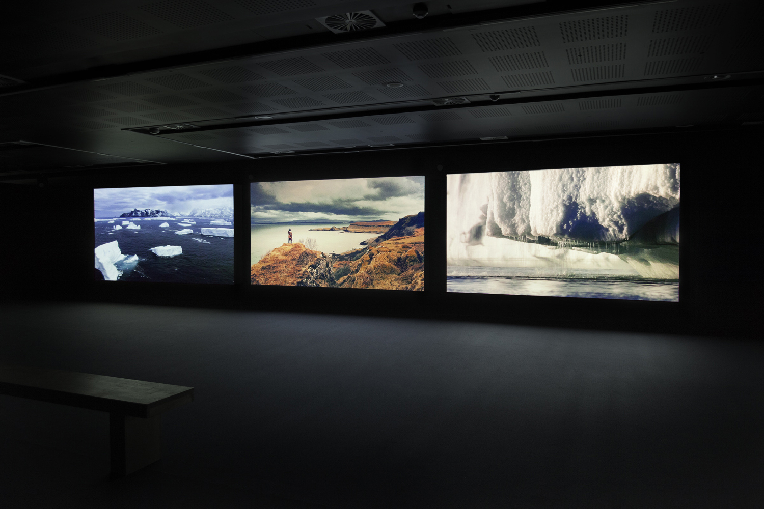 Installation view depicting three landscapes