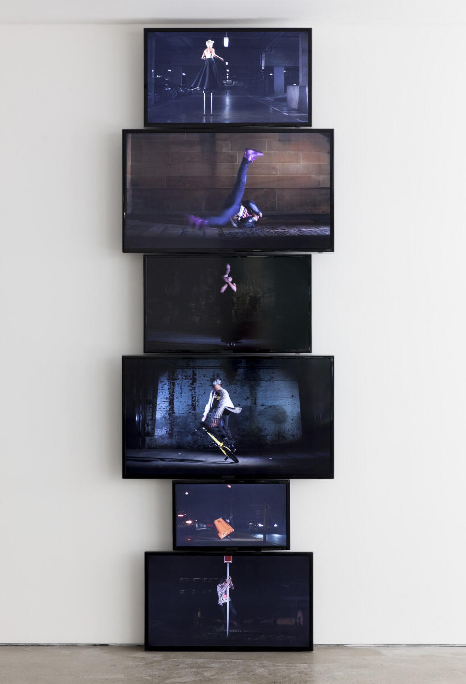 Installation view of multiple screens stacked ontop of one another