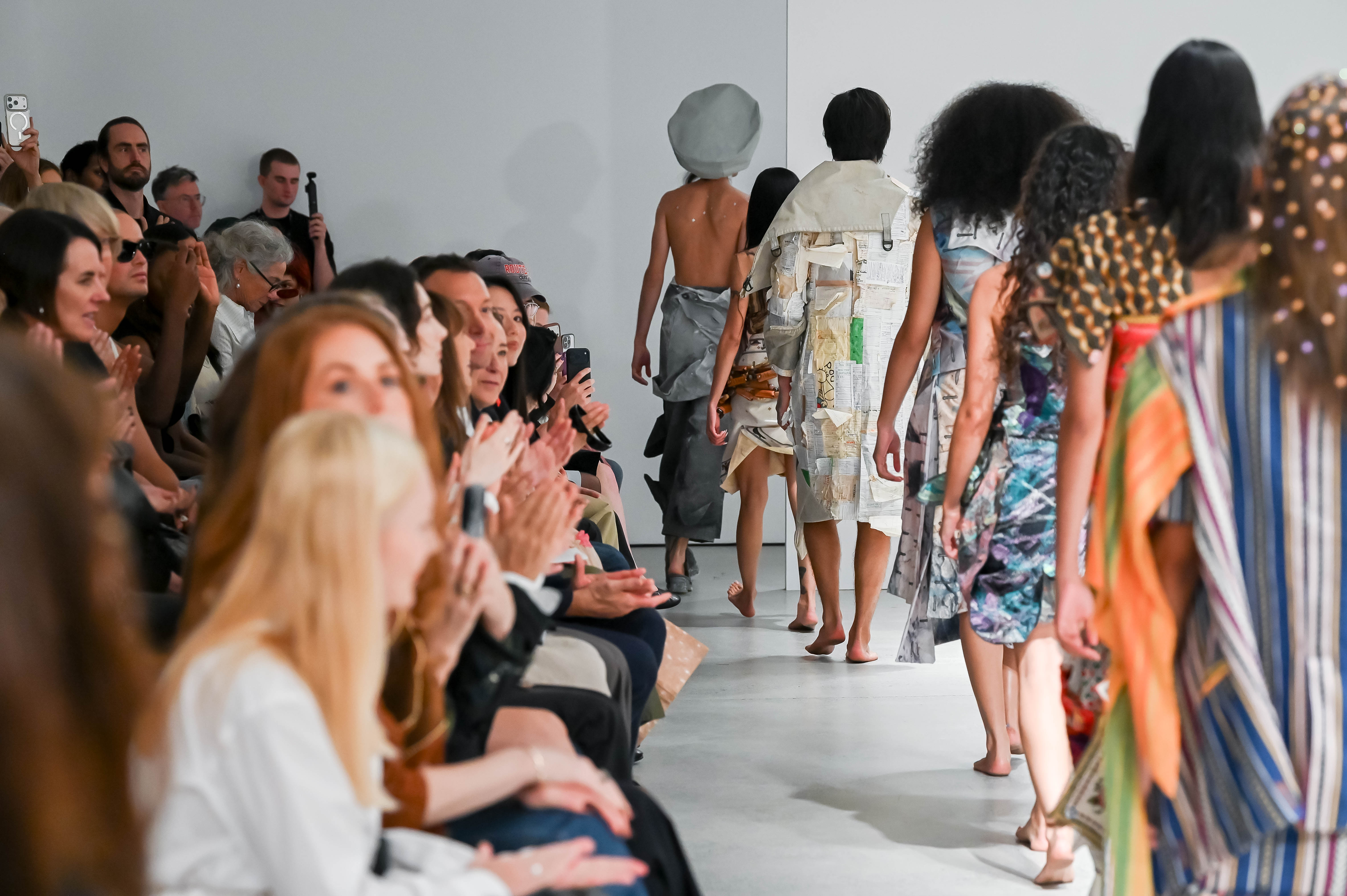 Runway and audience watching in white gallery