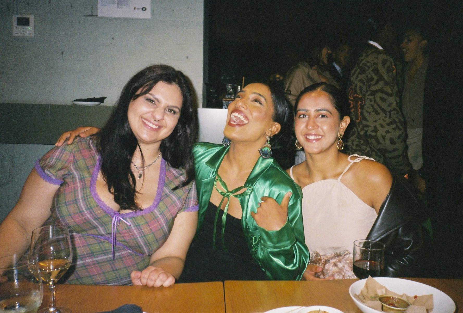 three smiling women at party