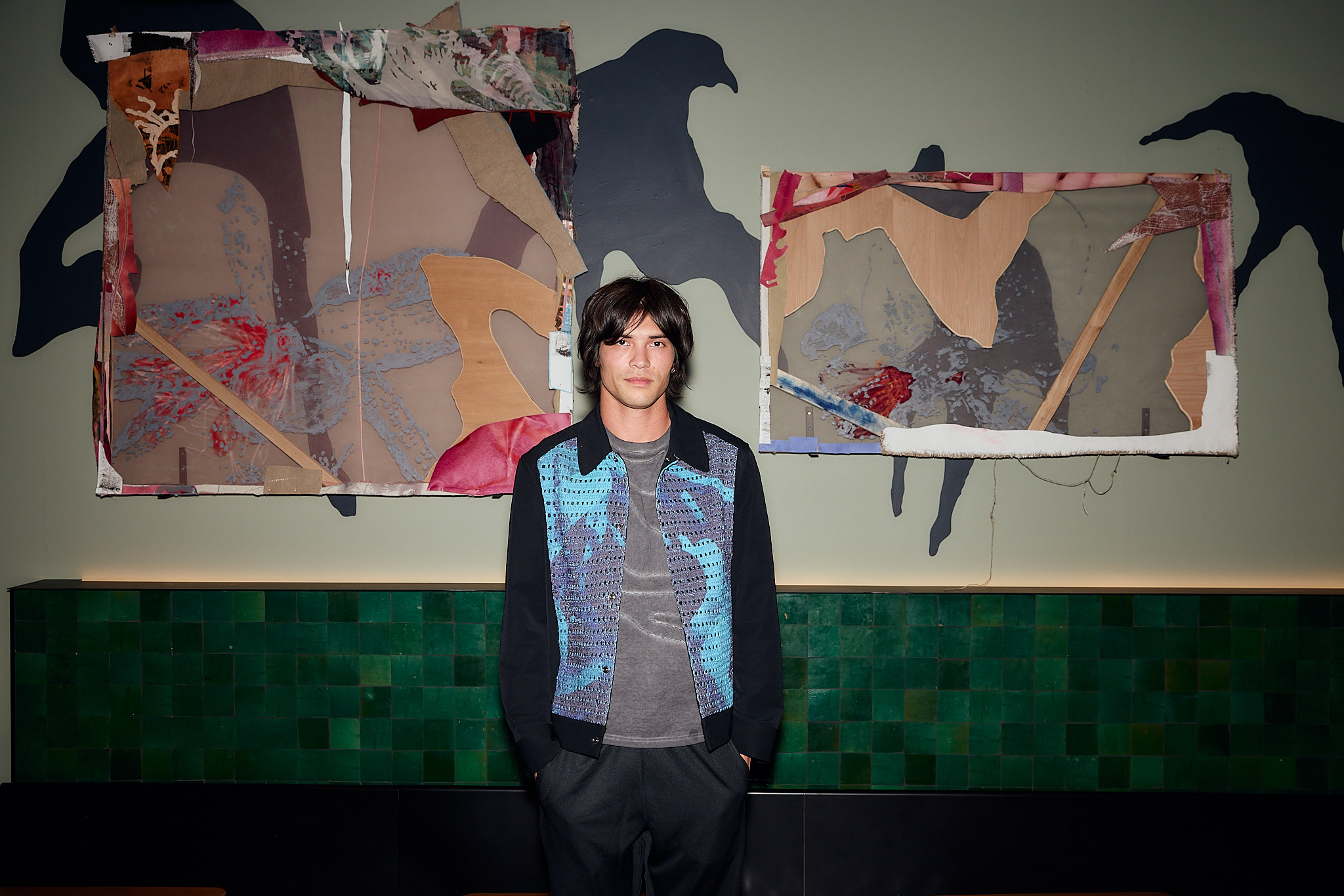 Remy Faint in Ace Hotel in front of artwork