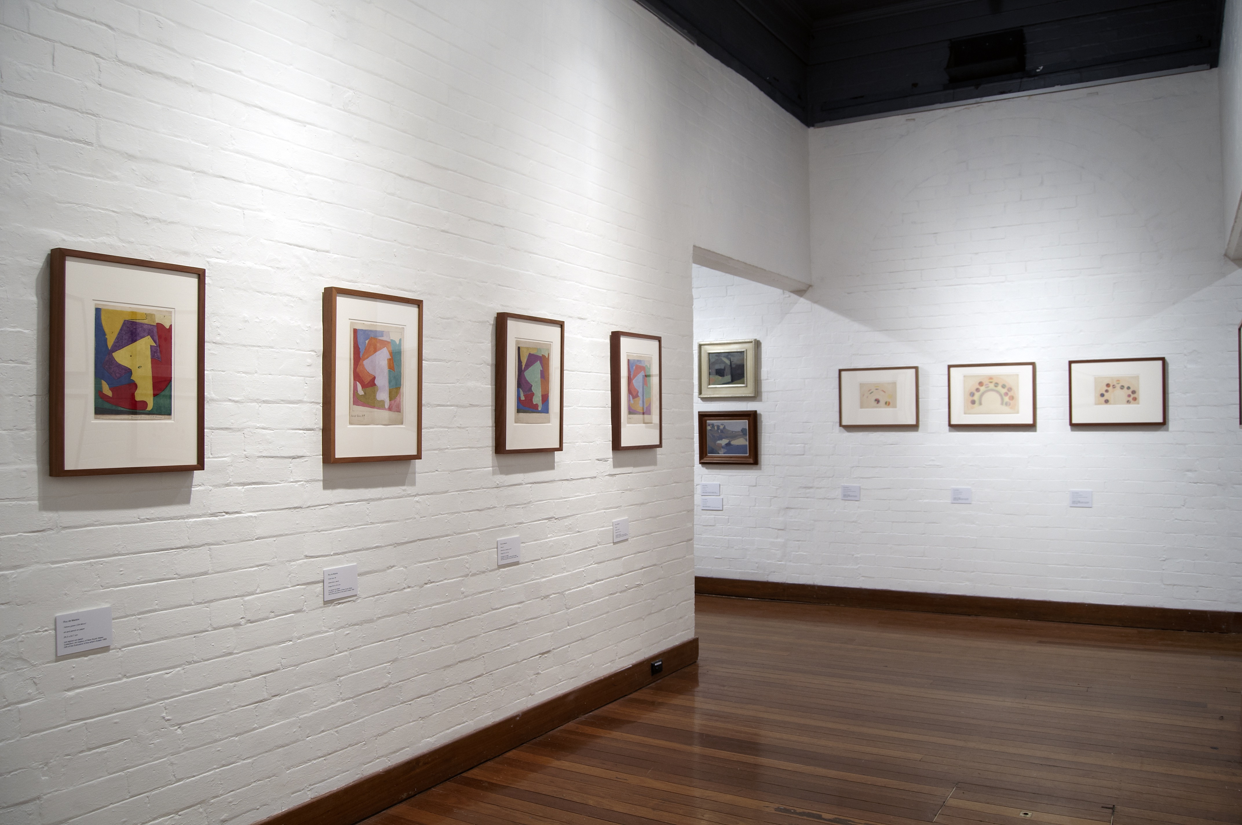 Multiple framed modernist and abstract paintings exploring colour theory.