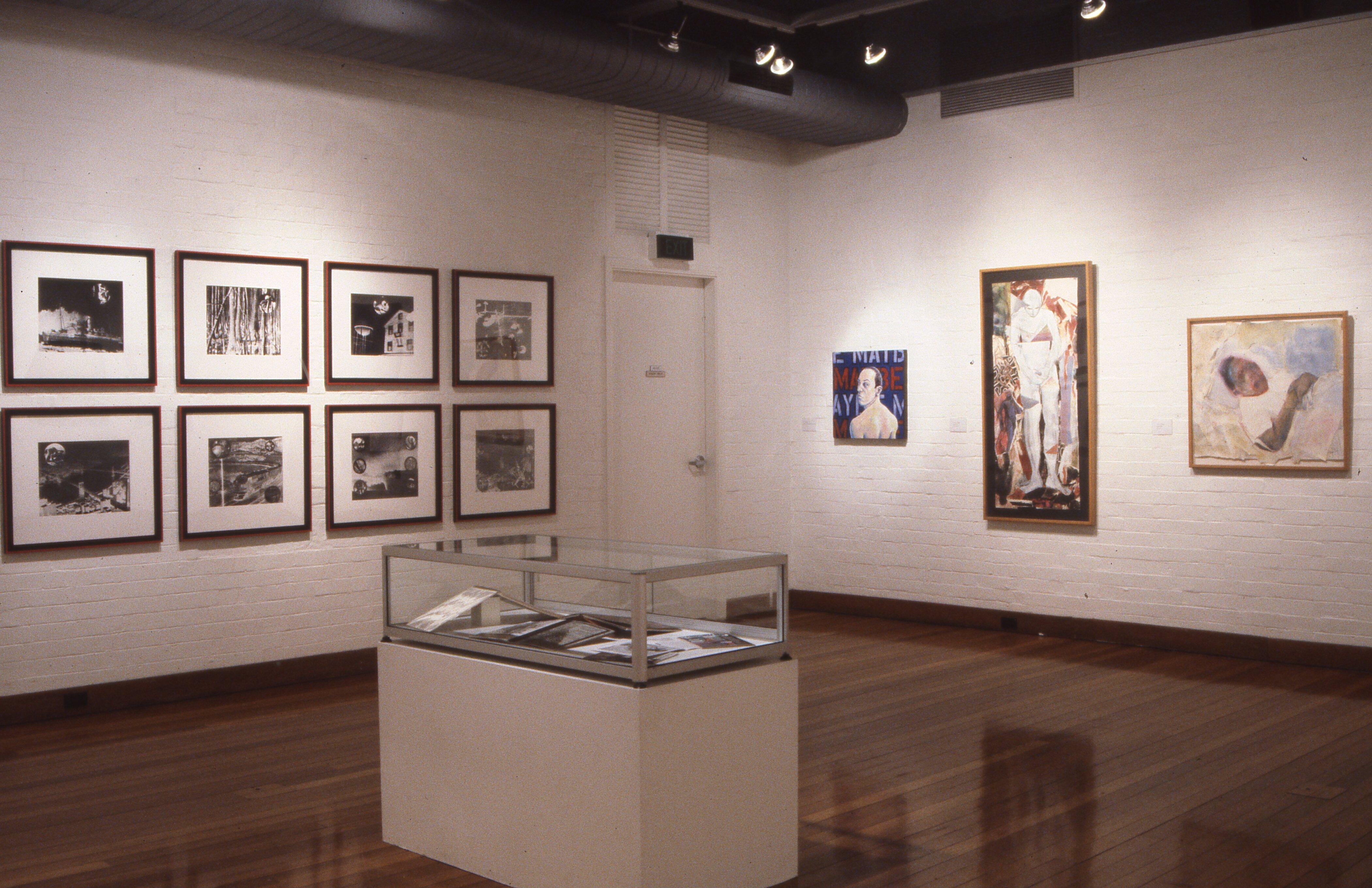 The image records the arrangement of contemporary artworks within the gallery environment, showing the exhibition layout, relationships between works, and the curatorial presentation of art addressing themes of AIDS, activism, sexuality, loss, and cultural memory.