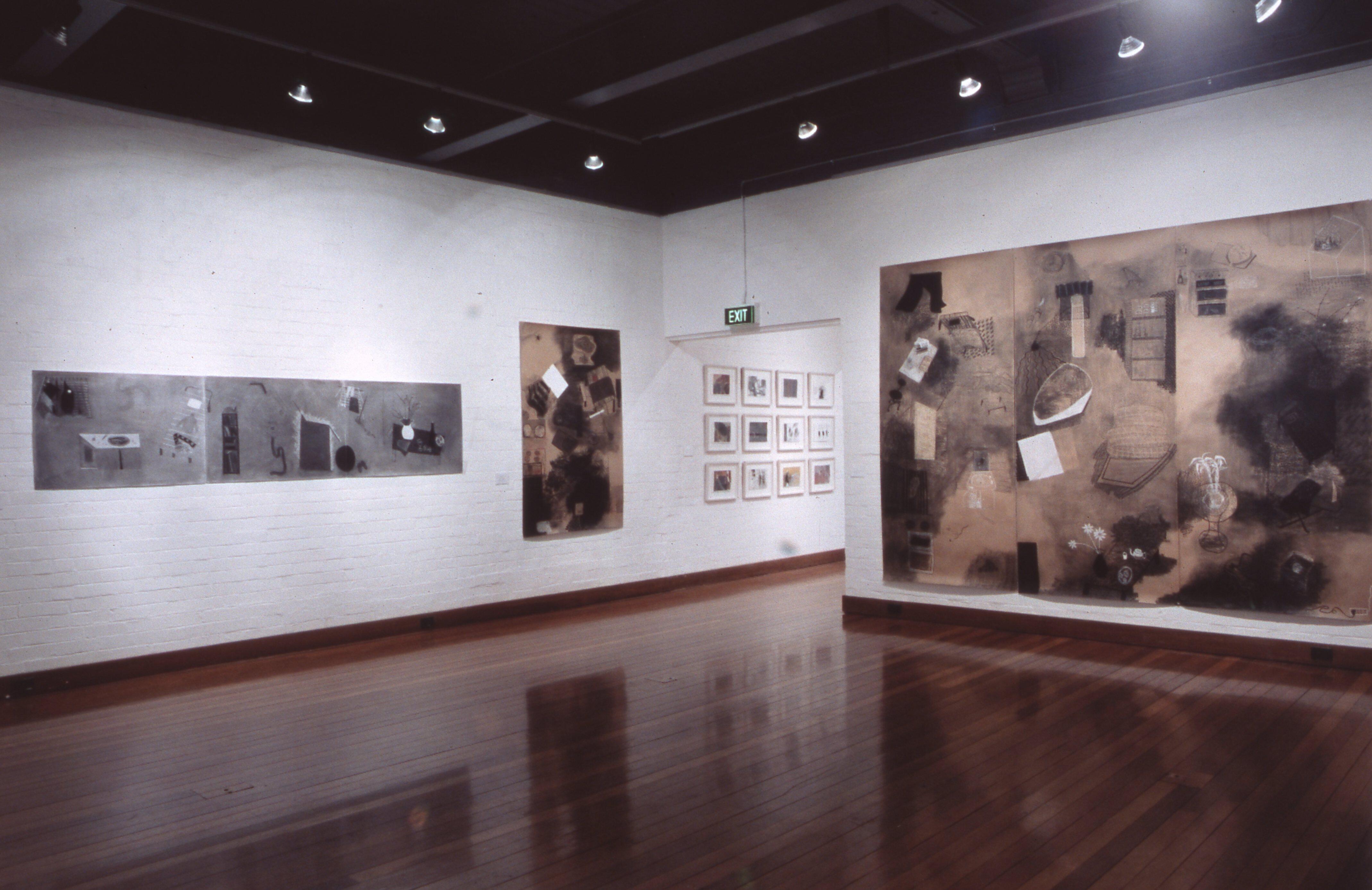 Installation featuring multiple prints, and drawings arranged directly on the wall in a structured layout.