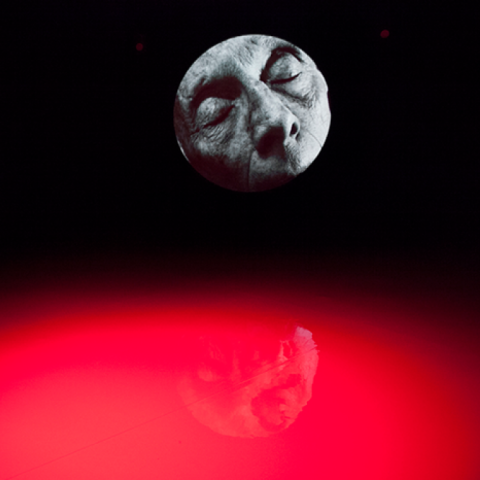 Red glow with a black and white image of a face