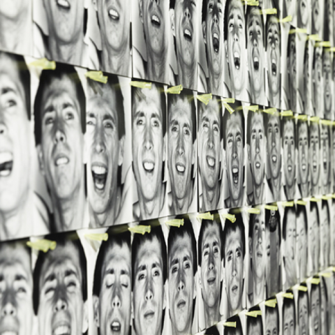 A wall of face photographs