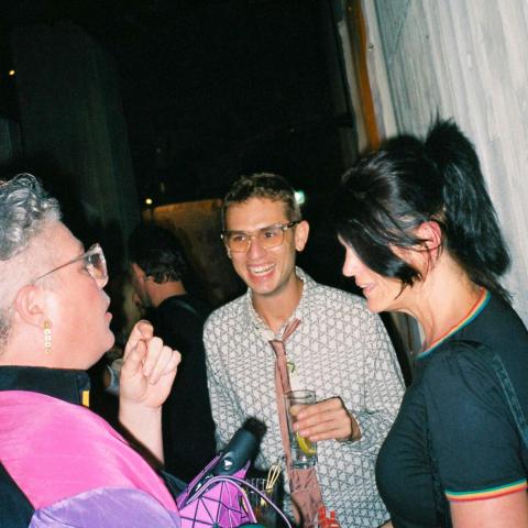 three people laughing and talking