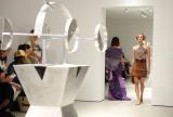 Runway and audience watching in white gallery