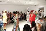 Runway and audience watching in white gallery
