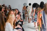 Runway and audience watching in white gallery