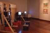 Installation showing a sculptural work with soldier cut outs and video works