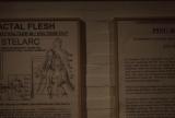 Two framed informational posters about Stelarc’s “Fractal Flesh” and “Ping Body” projects mounted on a white gallery wall.
